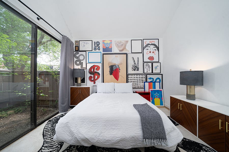 Modern, stylish bedroom with a Queen bed, black out curtains and a private patio.