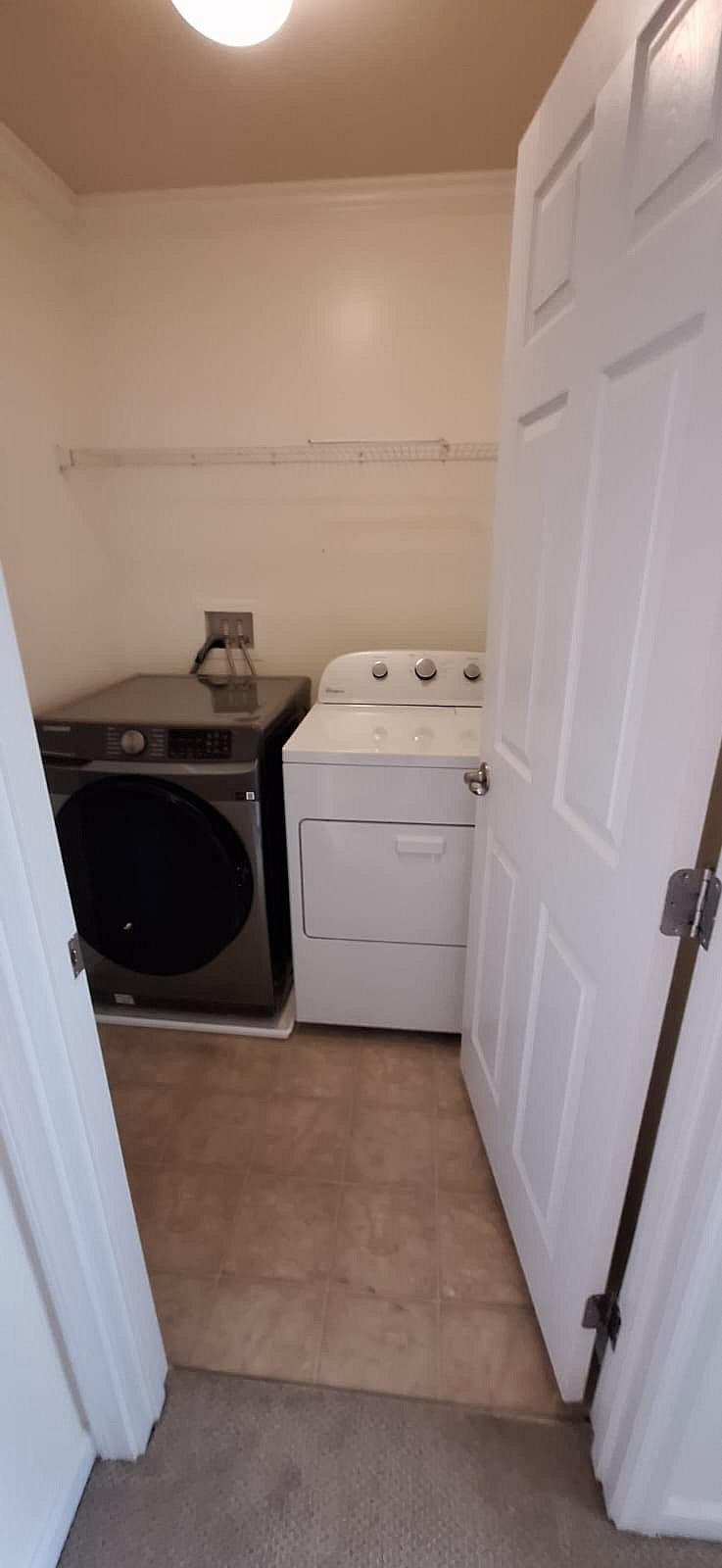 Laundry room with lots of shelving