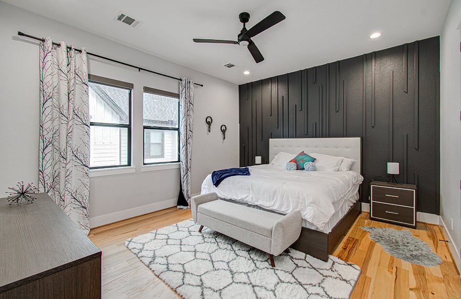 Retreat to the private primary suite featuring a comfortable king bed, luxurious ensuite bathroom, and generous closet space. Blackout curtains provide a restful environment for day or night sleep, making this room ideal for traveling nurses and medical professionals with varying schedules.