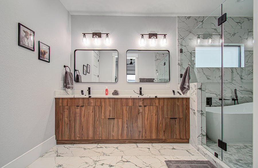 Spa-like primary bathroom featuring double vanities, a spacious walk-in shower, and a freestanding soaking tub. Designed for relaxation and comfort, it offers a luxurious retreat perfect for unwinding after a long day at the Texas Medical Center.