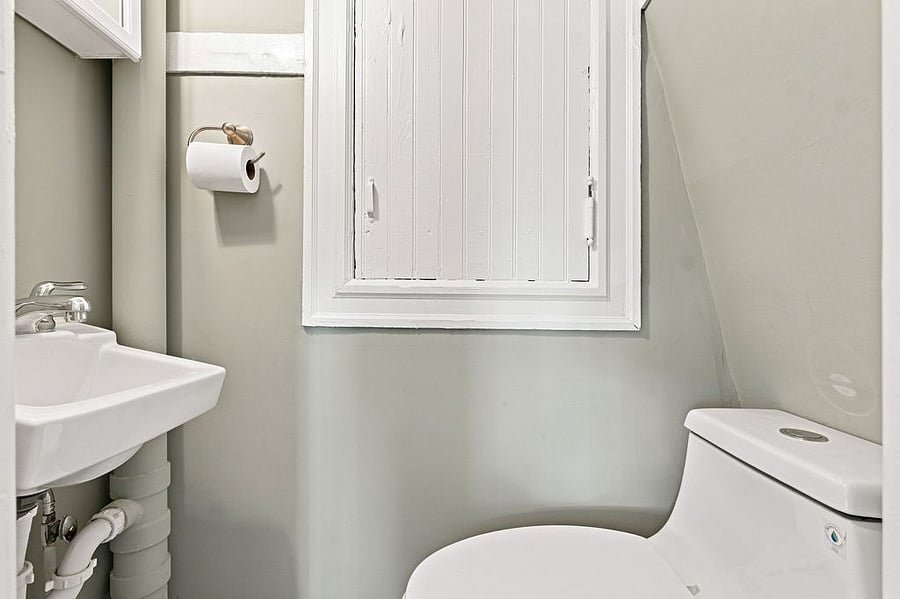 En suite half bath on second floor equipped with blow dryer and curling iron