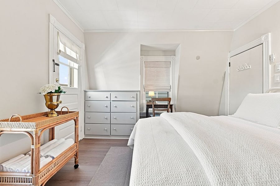Primary Bedroom with balcony and full sized bed
