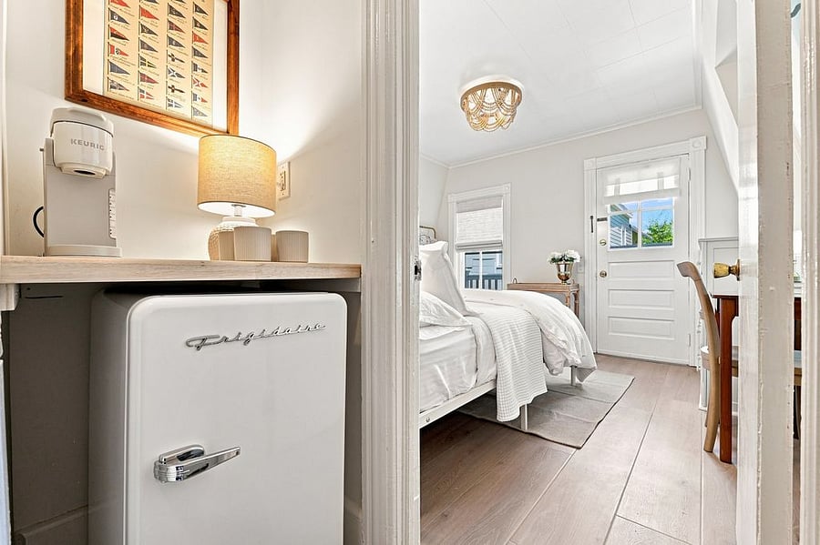 Coffee station with retro inspired mini fridge right outside the primary bedroom as an added luxury during your stay