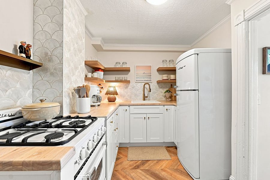 Step into our charming retro-inspired kitchen, updated with modern conveniences. Enjoy coffee and toast from our Smeg appliances. Other amenities include an electric kettle, mugs, glassware, dishes, utensils, and Our Place pots and pans