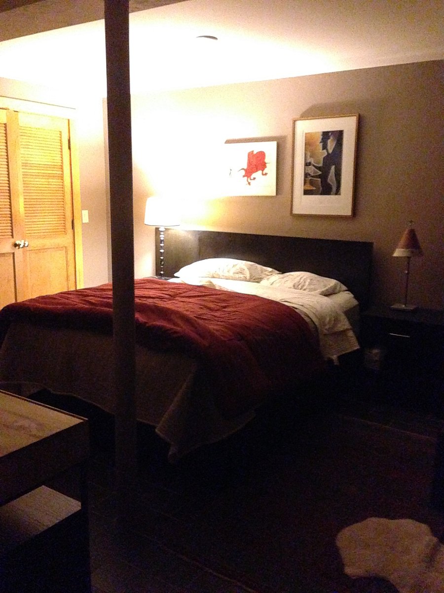 Bedroom with full bed, closet, desk, good lighting, chest-of-drawers.
