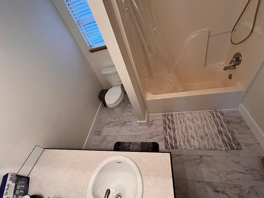 Guest bathroom, brand new shower valve, shower head, luxury vinyl plank flooring, brand new toilet.