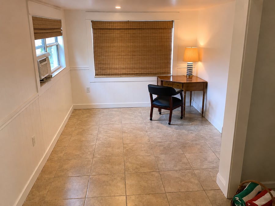 Bonus room with desk, chair, and lamp. A simple office space for remote work or studying.