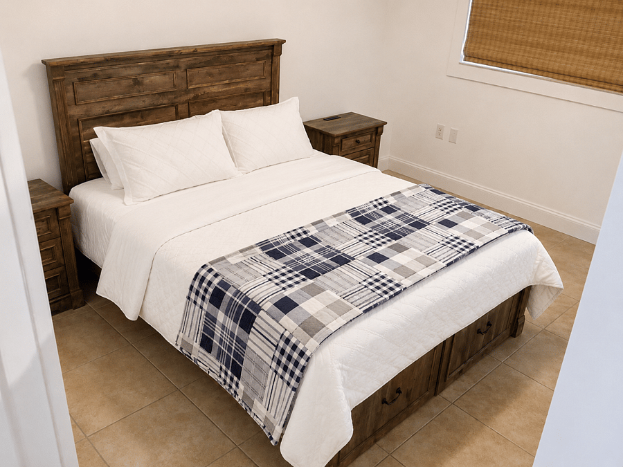 Bedroom 2 with a queen bed, simple furnishings, and a comfortable setup for longer stays.