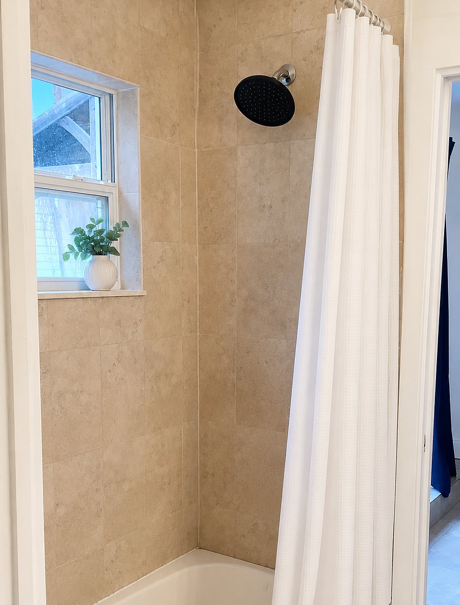 Shared bathroom between both bedrooms with a tub/shower combo, sink, and toilet.