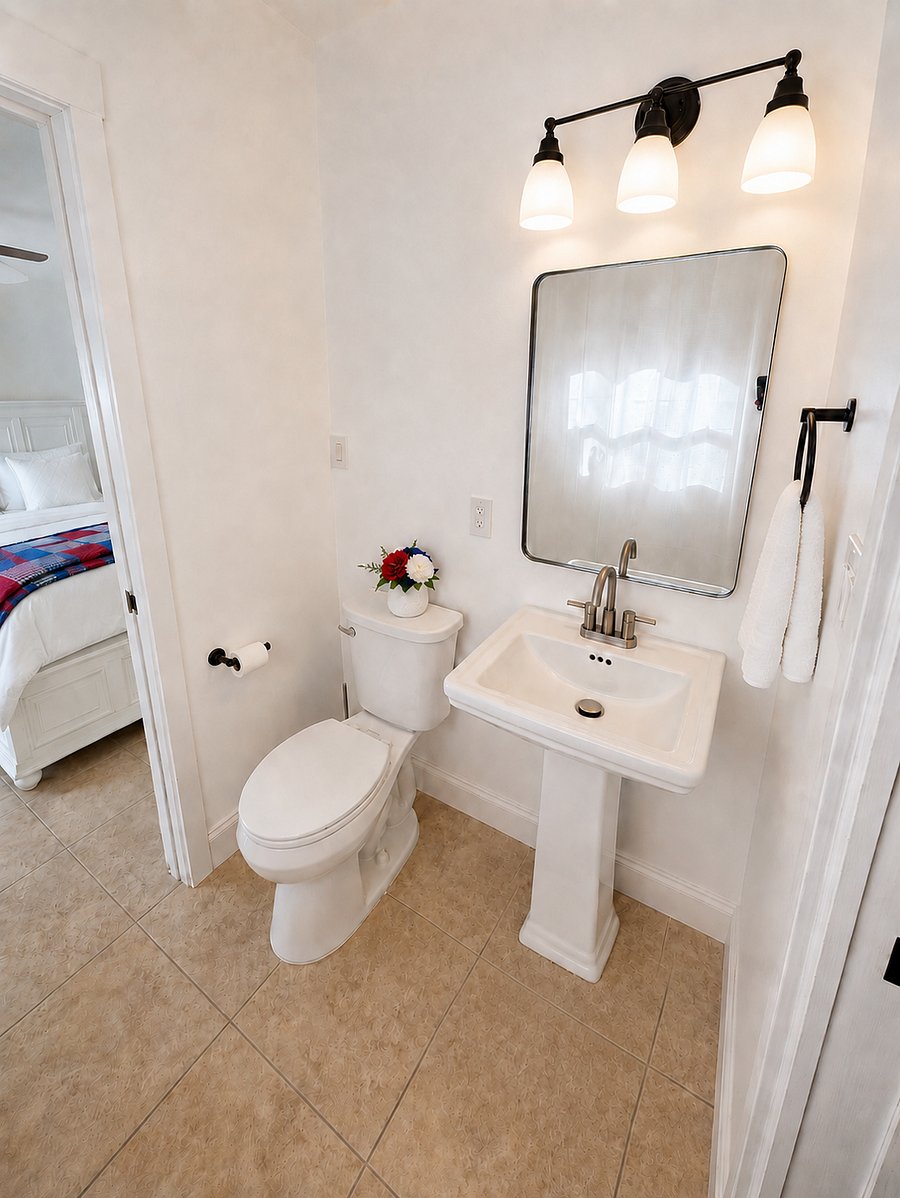 Shared bathroom between both bedrooms with a tub/shower combo, sink, and toilet.