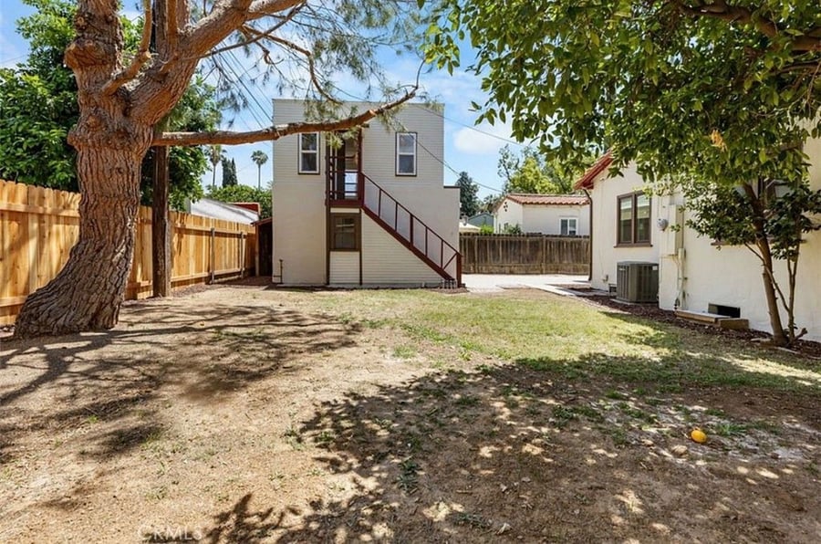 View of backyard and upstairs entrance to the studio unit. 