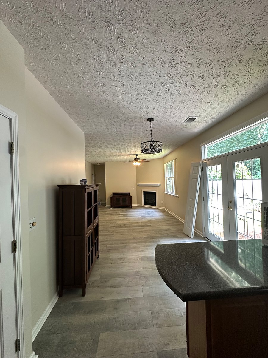 Dining and living room. French doors to fenced yard. 