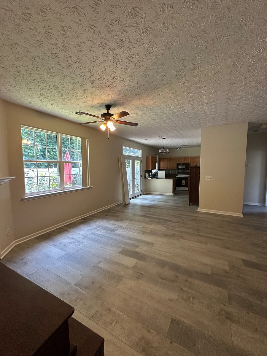 Living, dining and kitchen. French doors to fenced yard. 