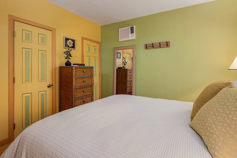 A new built-in closet offers hanging space (hangers included), shelving, and floor storage, while a 5-drawer bamboo dresser handles folded clothes and personal items. About 10 inches of clearance under the bed is handy for stashing luggage. 