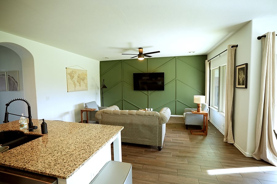 65 inch smart TV, comfortable seating, ceiling fan.