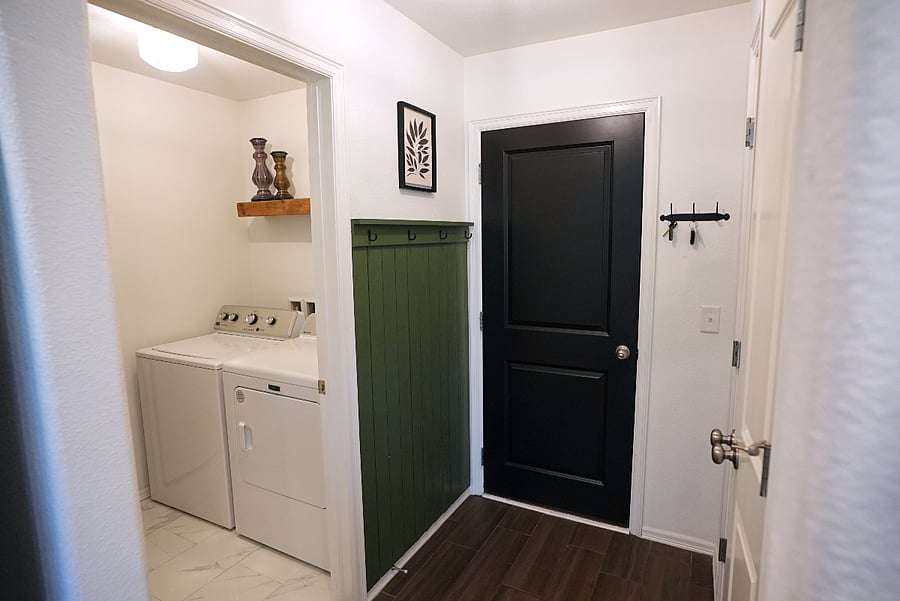 Full sized washer and dryer off of the garage entrance.
