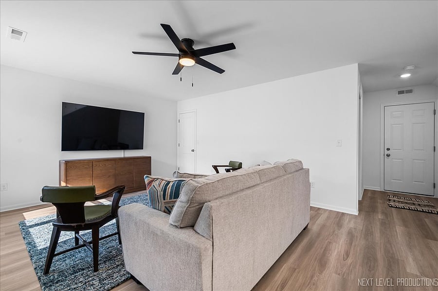 Downstairs Family Room can double as a bedroom. Large, wall-mounted TV.