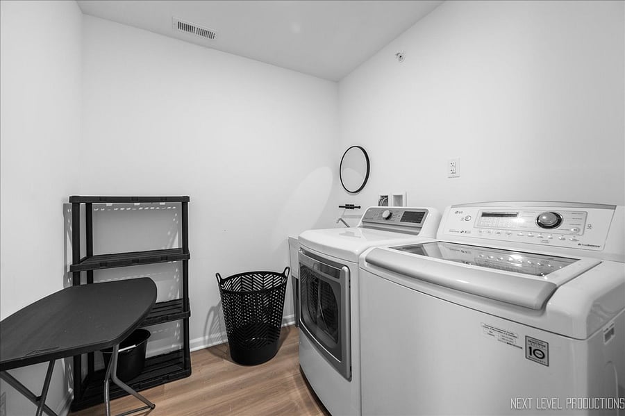 Laundry room with full size Washer & Dryer (with steam), & utility sink.