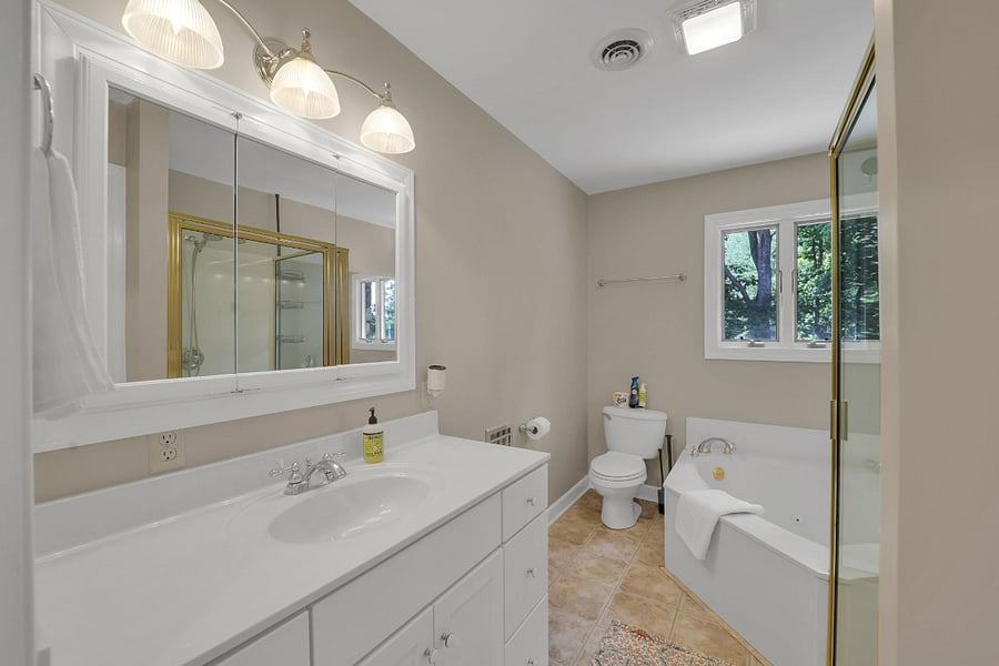 Upstairs bathroom featuring a jetted tub