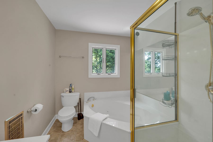 Upstairs bathroom featuring a jetted tub