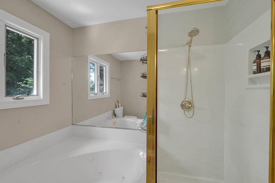 Upstairs bathroom featuring a jetted tub