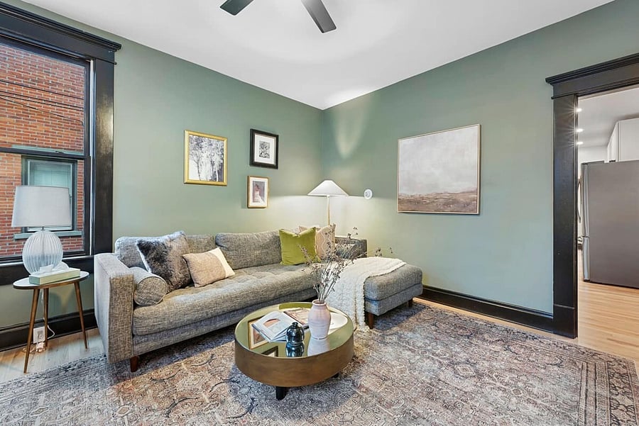 The wifi router is located behind the couch.