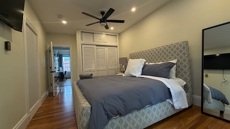 King bedroom 1 w/ mounted TV and closets 