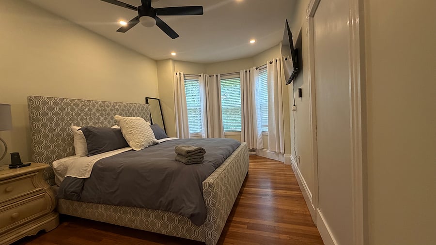 King bedroom 1 w/ mounted TV