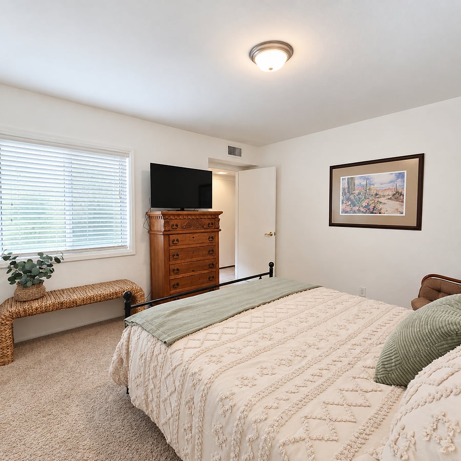 Second bedroom with Queen bed, Smart TV, wicker bench and custom dresser.