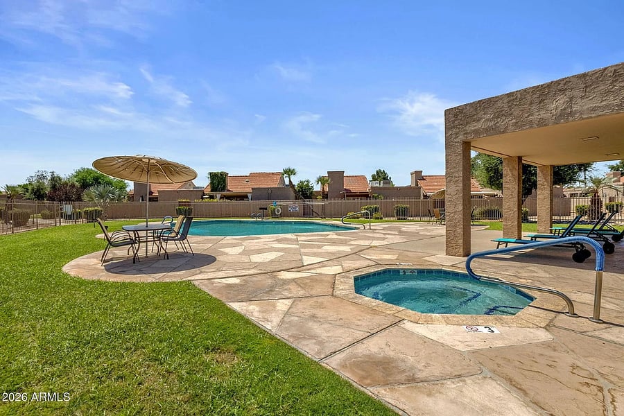 One of 2 gated pools with hot tubs, tables and chairs. Covered area includes chaise lounges and restrooms