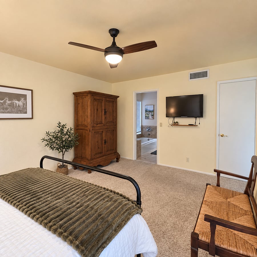 Primary Bedroom features ensuite, Smart TV and large walk-in closet