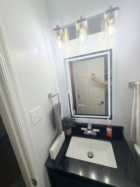 Bathroom Vanity area with defogging mirror