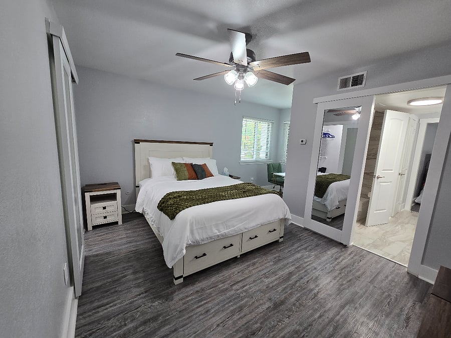 Your primary suite has natural lighting, a full-length mirror, walk-in closet, and ample storage.