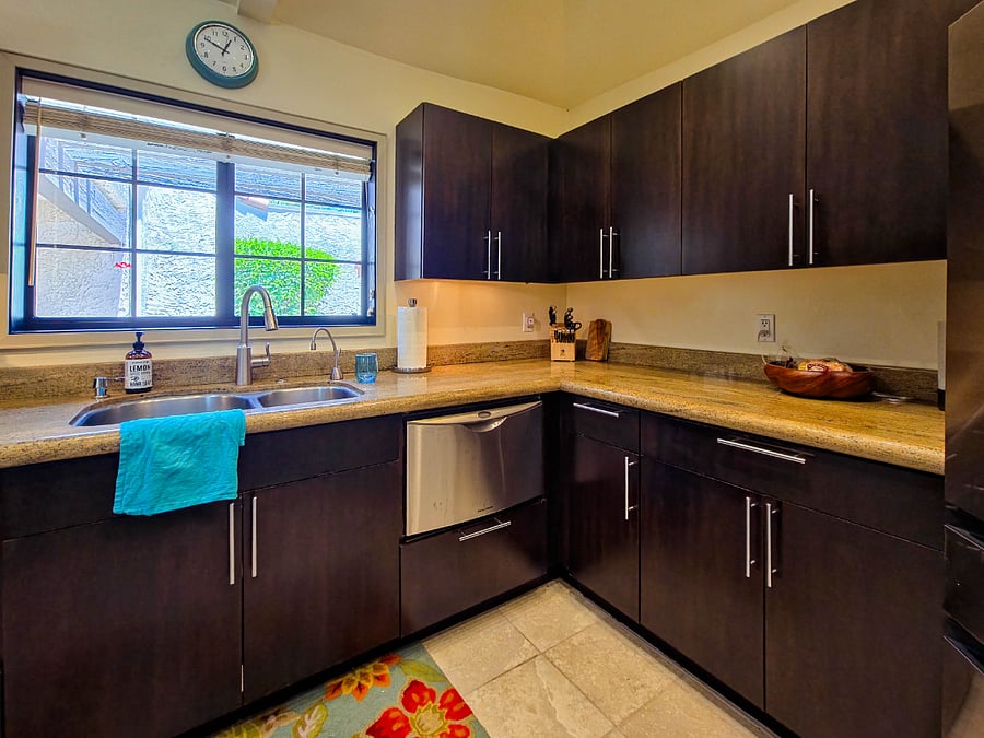 Kitchen sink with insta-hot water tap and dishwashers on each side of sink.
