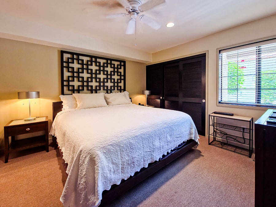 Secondary bedroom with king-size bed, ample wall closet and dresser.