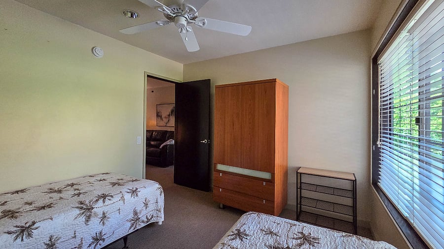 Third bedroom with 2 twin beds, wardrobe closet and dresser.