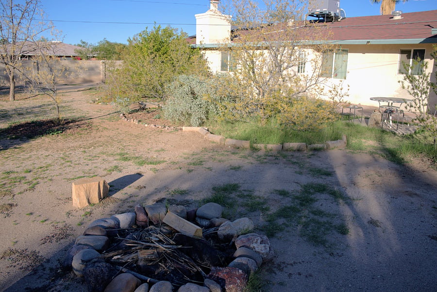 Stone-ring firepit in backyard
