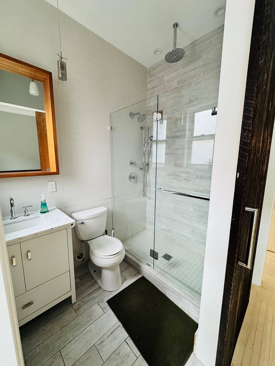 Bathroom with hand held, standard or rain shower.