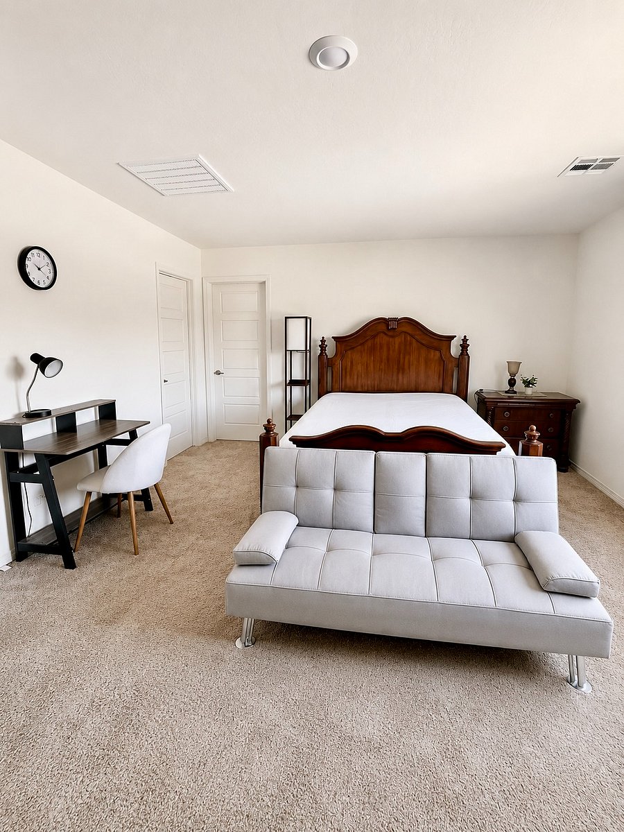 Master bedroom with en-suite bathroom and additional seating area. Futon folds down for extra sleeping space for guests.
