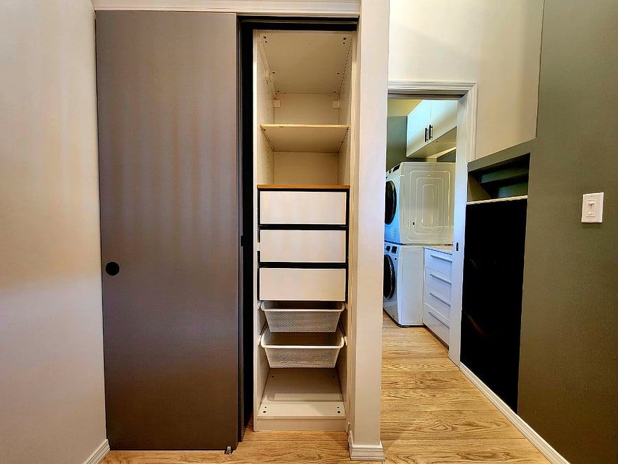 Thoughtfully designed closet with hanging space on one side and drawers on the other, everything has a place!