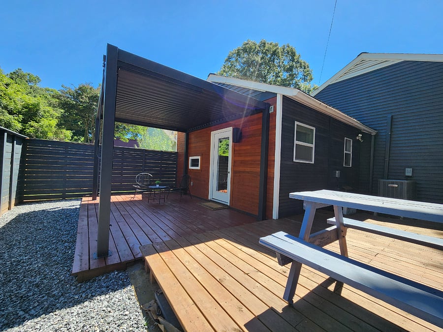 Private deck with an adjustable pergola roof to enjoy Charlottes beautiful weather year-round.