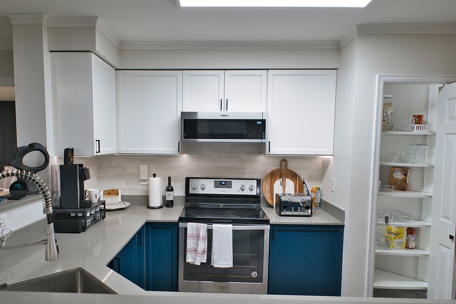 Kitchen - stainless steel appliances, coffee maker, toaster, microwave and pantry with plenty of storage space