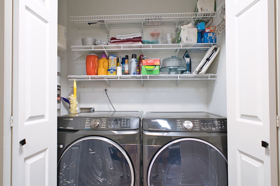 Samsung Washer and Dryer, iron and board, and additional storage space.