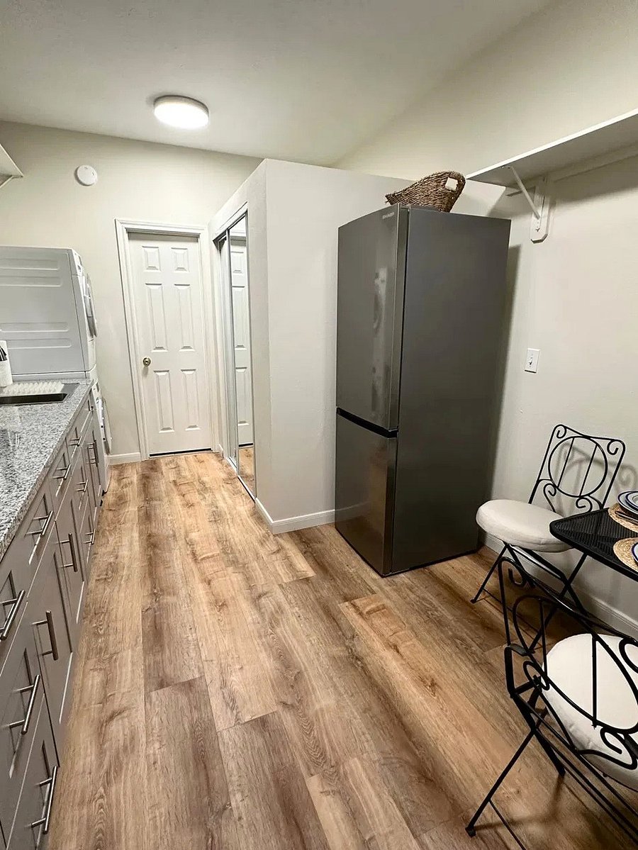 Private kitchenette area with full-size refrigerator, cabinet storage, countertop space, sink, microwave, and a small dining area. The space also includes a washer and dryer, plus a walk-in closet for additional storage.
Clean, updated, and convenient for professionals who prefer a comfortable space for meal prep, laundry, and feel at home.