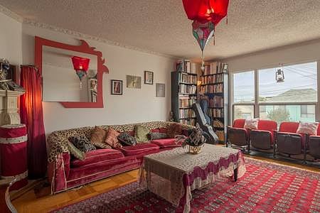 Big Living Room, with movie screen and seating, exercise equipment and library