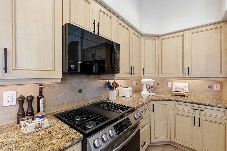 Kitchen is stocked with spices, cooking oils, and essential pantry supplies.