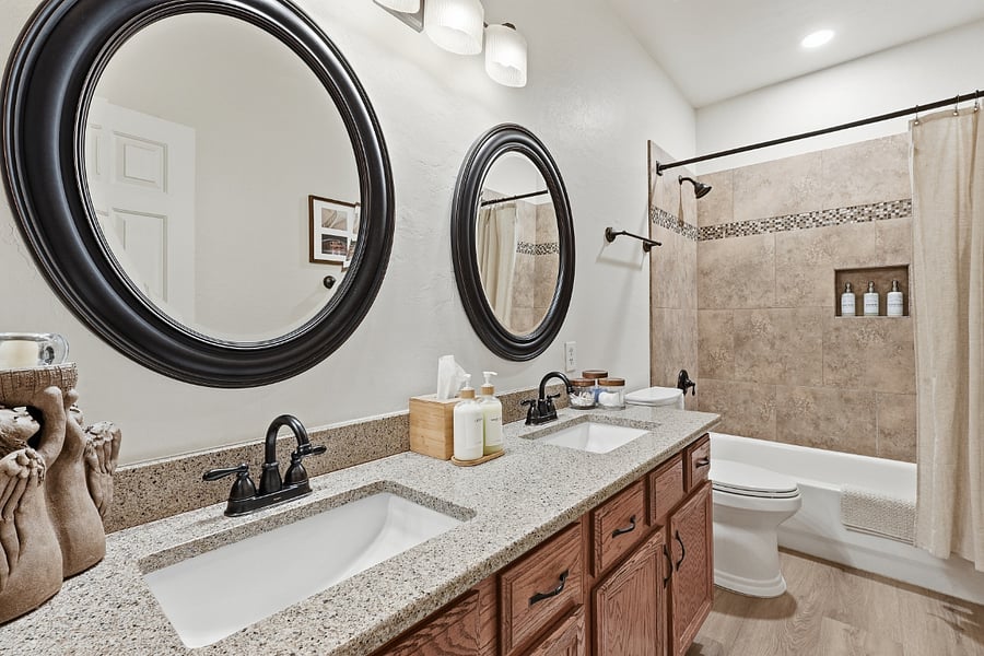 Bathroom in hallway with tub/shower and double vanities. Towels and essential toietries provided, along with a starter supply of toilet paper and tissues.