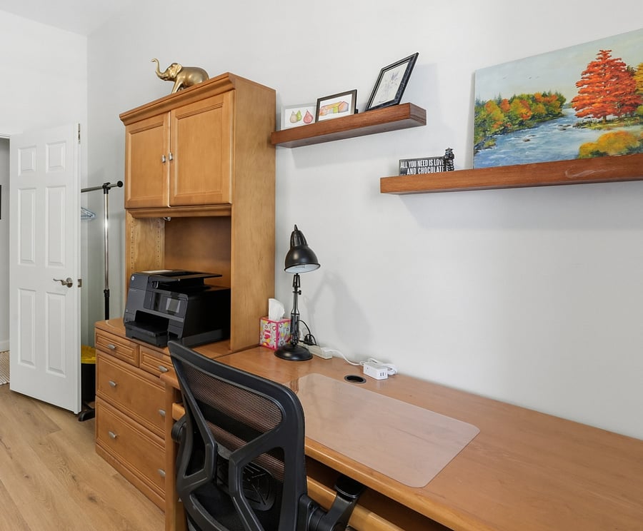 Bedroom 4 with shared office and twin bed space. Portable closet located behind the door for hanging clothes.