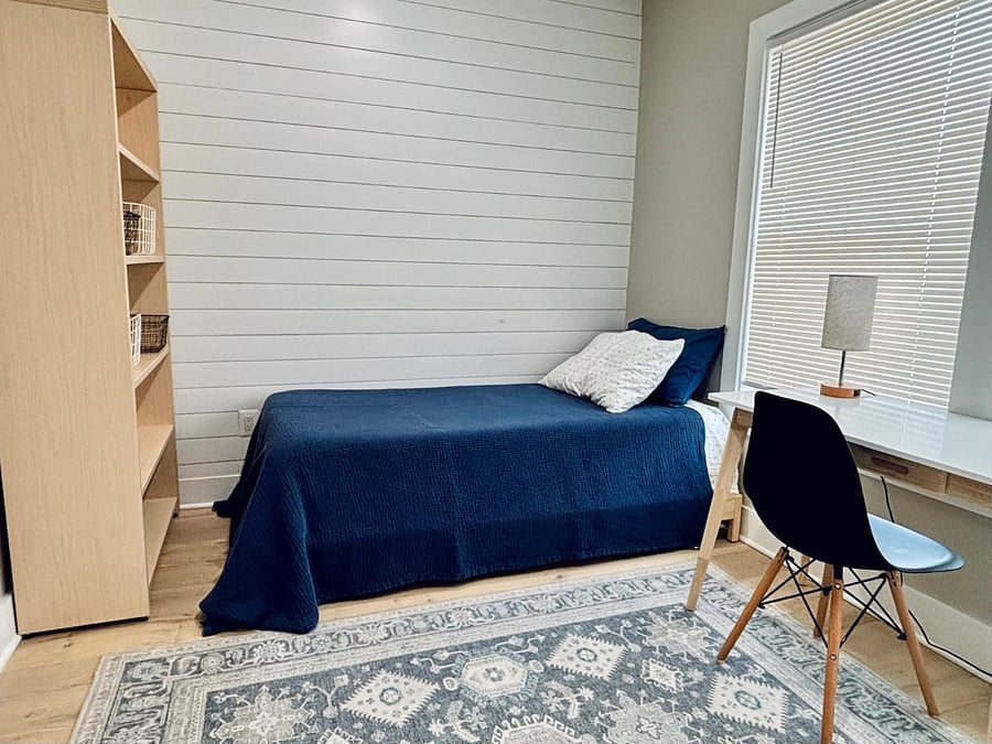 Second bedroom/office with desk, bookcase, twin bed, and closet