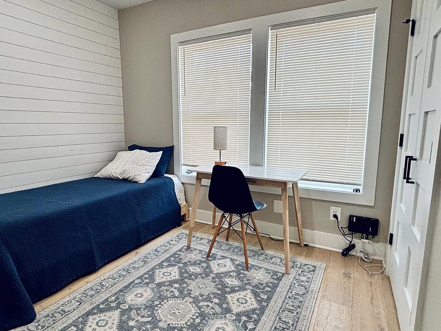 Second bedroom/office with desk, bookcase, twin bed, and closet